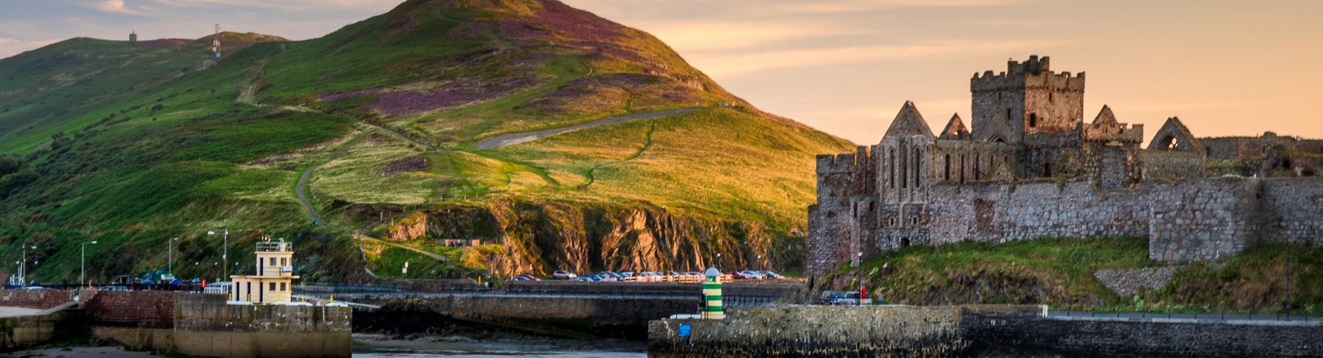 Peel Castle and Corrin's Hill at dusk shown from the sea