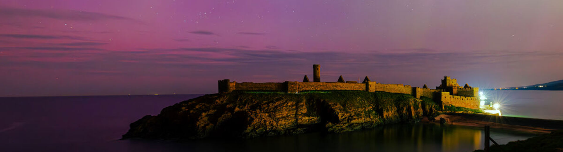Peel Castle on the Isle of Mean backlit by the northern lights