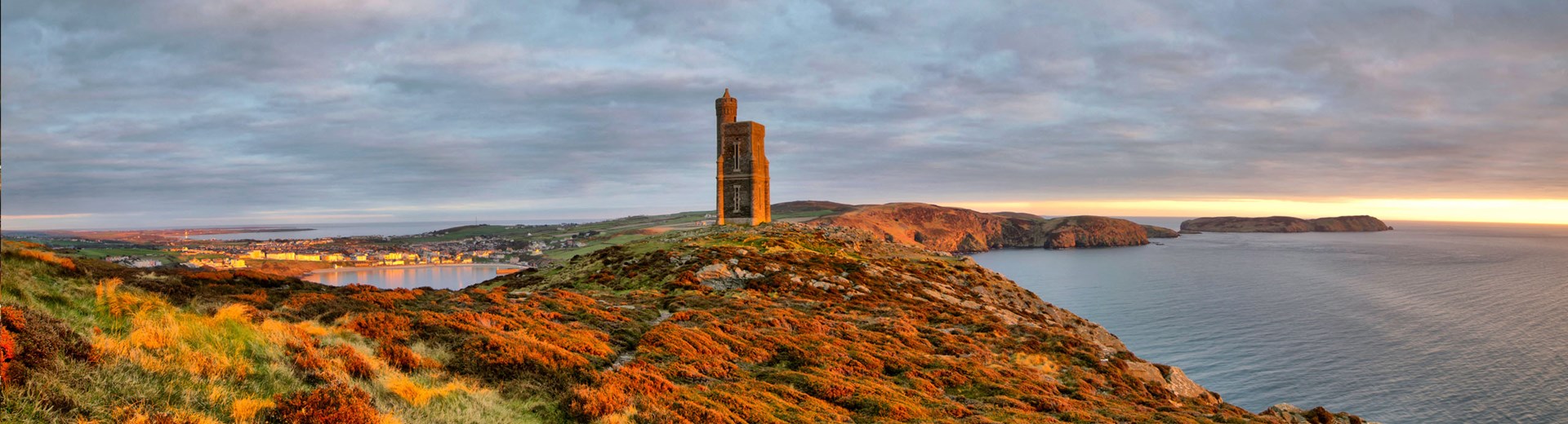 A tower on a hill at sunset. The tower is Corrin's folly on the Isle Of Man